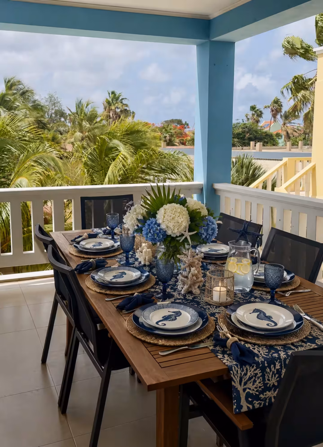 Outdoor dining table with blue nautical theme.
