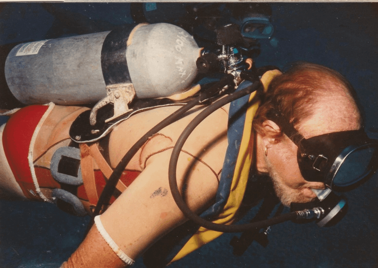 Scuba diver underwater with oxygen tank.